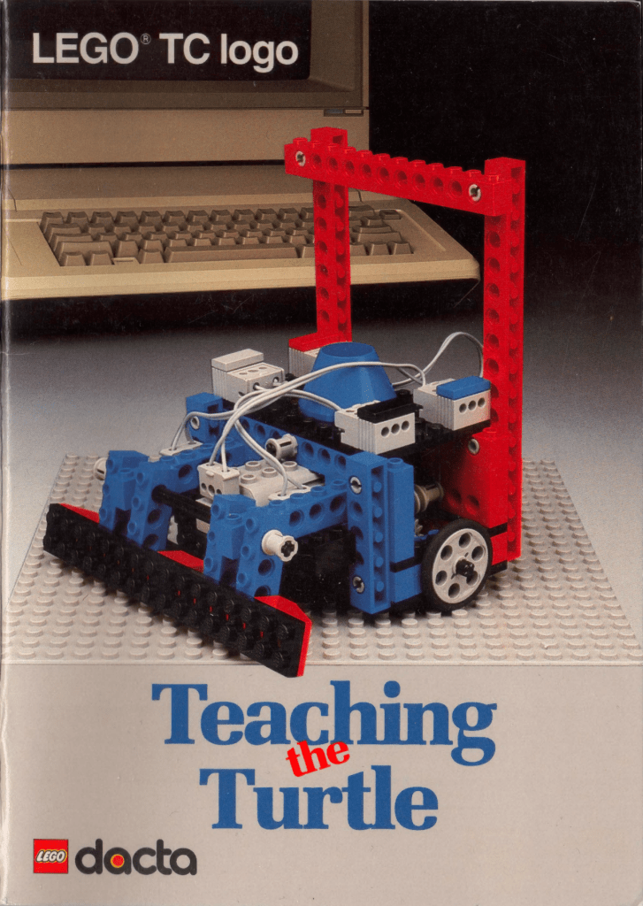 Cover of the LEGO TC logo book titled 'Teaching the Turtle,' featuring a blue and red LEGO robotic structure on a baseplate with a computer in the background.